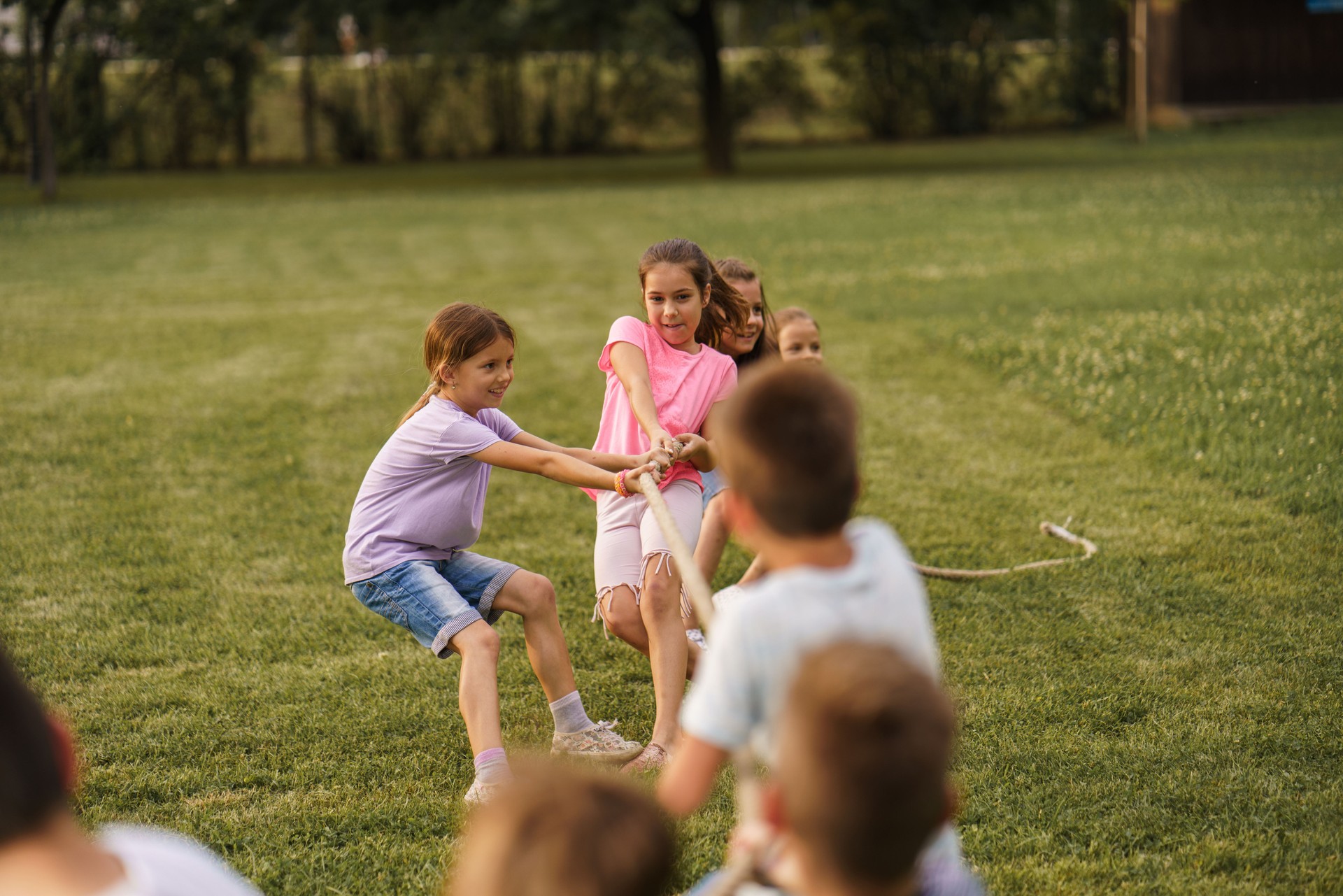 Children playing Tug of war game outdoors